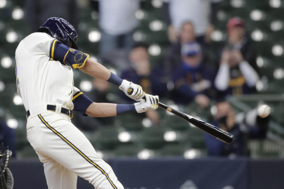 Milwaukee Brewers' Christian Yelich hits an RBI single during the ninth inning of the team's opening-day baseball game against the Minnesota Twins on Thursday, April 1, 2021, in Milwaukee. (AP Photo/Aaron Gash)