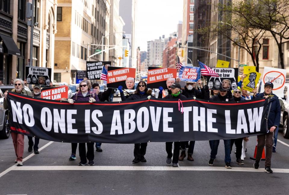 Anti-Trump protesters outside his first criminal trial on 25 April 2024 (EPA)