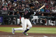 Arizona Diamondbacks left fielder Lourdes Gurriel Jr. hits an RBI double against the Colorado Rockies in the first inning during a baseball game, Saturday, March 30, 2024, in Phoenix. (AP Photo/Rick Scuteri)