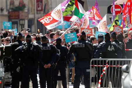 French riot policemen watch on an anti-Macron "festive" protest called by far-left opposition "France Insoumise" (France Unbowed) political party, two days ahead of the first anniversary of his election as President, in Paris, France, May 5, 2018. REUTERS/Charles Platiau