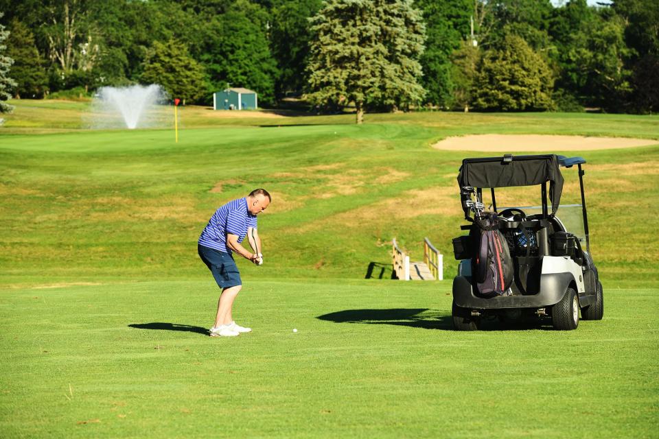 Brett Yeomans, of Ledyard, takes his chip shot on the 14th fairway at the Norwich Golf Course Thursday.