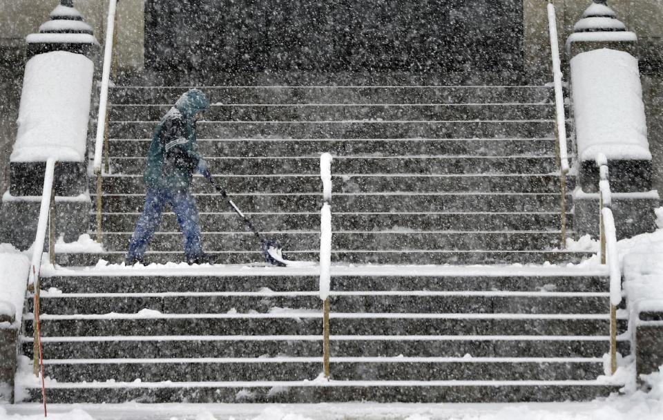 A worker shovels snow Monday, Jan. 3, 2014, in Trenton, N.J. Another round of winter weather followed a day of unseasonable temperatures with several inches of snow in the eastern United States on Monday. (AP Photo/Mel Evans)