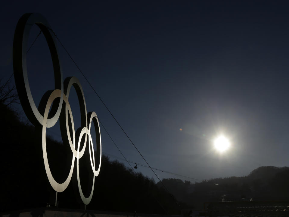 The sun rises above the Caucasus Mountains beyond a set of Olympic Rings Thursday, Feb. 6, 2014, in Rosa Khutor, Russia. The area will host the alpine events at the 2014 Winter Olympics which opens Friday, Feb. 7. (AP Photo/Charlie Riedel)