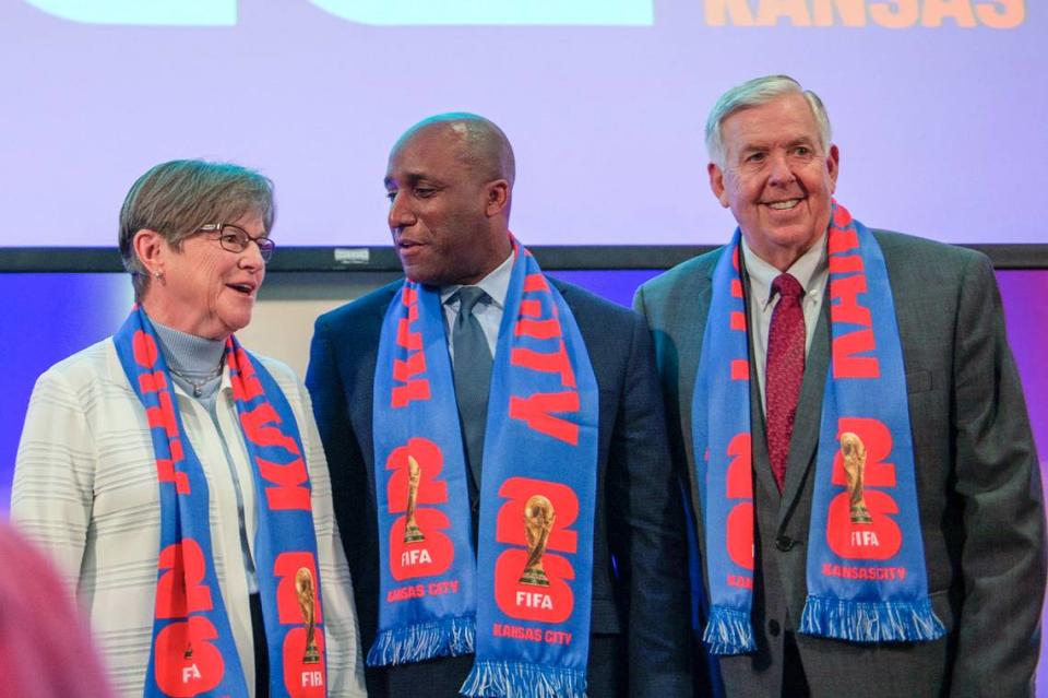 Kansas Governor Laura Kelly, left, Kansas City Mayor Quinton Lucas, and Missouri Governor Mike Parson pose for photos after a press conference regarding FIFA World Cup 2026 at GEHA Field at Arrowhead Stadium on Thursday, May 18, 2023, in Kansas City.