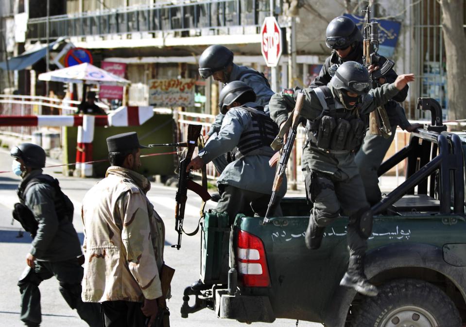 Afghan policemen arrive after a suicide bomber wearing a military uniform struck the entrance gate of the Interior Ministry compound in Kabul, Afghanistan, Wednesday, April 2, 2014. Ministry of Interior spokesman Sediq Sediqqi said the bomber, who was wearing a military uniform to evade security checks, reached the entrance of the heavily fortified ministry compound before detonating his explosives. (AP Photo/Massoud Hossaini)