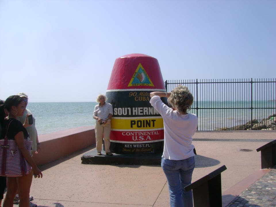 In this February 2012 photo, a tourist poses for a pictures at the monument marking the continental states’ southernmost point in Key West, Fla. (AP Photo/Glenn Adams)