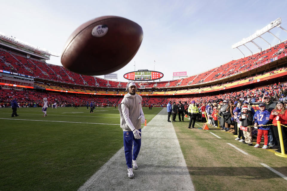 Buffalo Bills wide receiver Stefon Diggs tosses a ball towards a photographer while warming before the start of an NFL football game between the Kansas City Chiefs and Buffalo Bills Sunday, Dec. 10, 2023, in Kansas City, Mo. (AP Photo/Charlie Riedel)