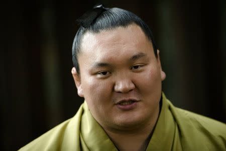 Mongolian-born grand sumo champion Yokozuna Hakuho talks to the media after performing the New Year's ring-entering rite at the Meiji Shrine in Tokyo January 7, 2015. REUTERS/Thomas Pete