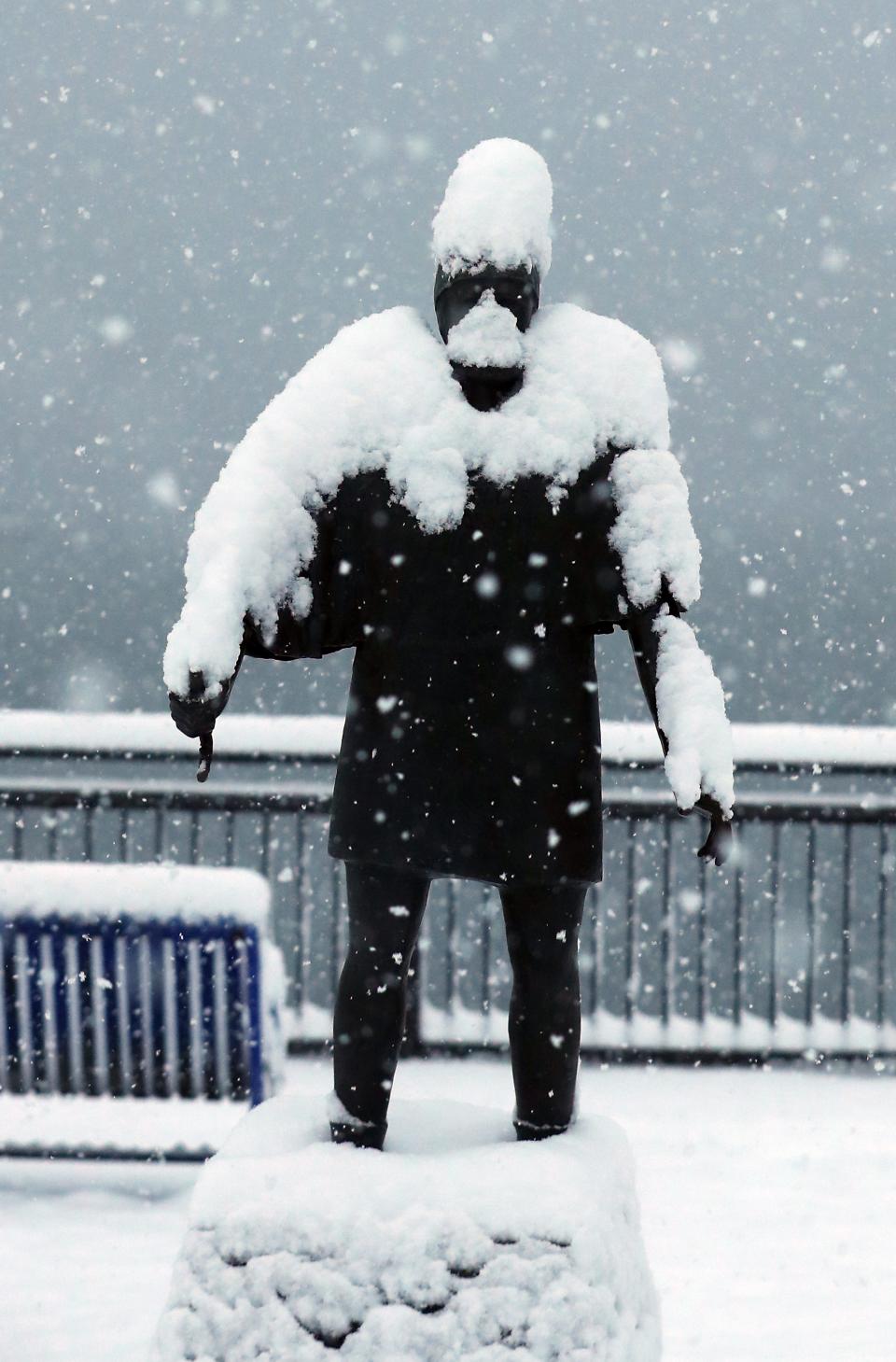 Heavy snow builds up on the viking statue at Poulsbo's Waterfront Park on Tuesday.