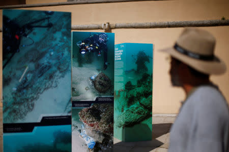 People watch the pictures during a news conference regarding the announcement of the discovery of a centuries-old shipwreck, in Cascais, Portugal September 24, 2018. REUTERS/Pedro Nunes