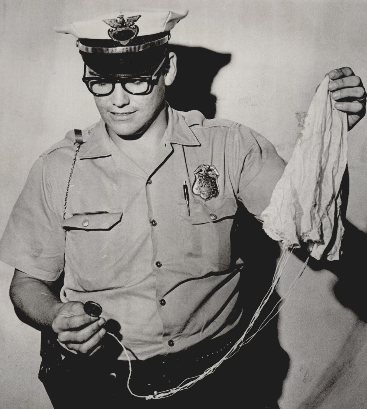 Oklahoma City police officer Richard Boyd holds a small parachute with a flare attached in 1965. For at three straight days, the front pages of The Daily Oklahoman reported numerous sightings of unidentified flying objects across the state, parts of the nation and South America. Residents were shaken by what they had seen in the sky: colorful flashing lights, a kite shaped object, striped and glowing triangular object, flying saucers, a floating white globe. "People are upset. They want to know what they are, and we can't tell them," an Oklahoma City police dispatcher said. Some officials proposed the numerous UFO sightings, many at high altitudes, might have been caused by meteors, a bright evening star, balloons, optical illusions and atmospheric conditions. Amid the ongoing calls to police, Boyd recovered the small parachute after it was seen floating down near SE 53 and Shields.