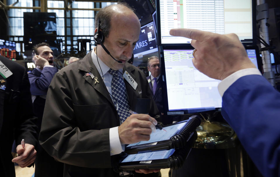 Trader Andrew Silverman, center, works on the floor of the New York Stock Exchange, Friday, May 2, 2014. U.S. stock futures are up slightly after the U.S. unemployment rate hit its lowest level in more than five years. The government reported the unemployment rate sank to 6.3 percent. (AP Photo/Richard Drew)