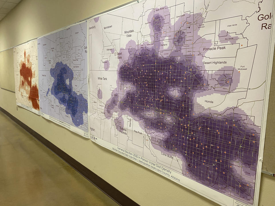 This Monday, Dec. 12, 2022, photo provided by Maricopa County Elections Department shows a heat maps of total in person turnout along side of the Republican in-person voter turnout, far left and Democrat in-person voter turnout, center during the 2020 general election displayed in the Maricopa County Elections Department's central tabulation facility in Phoenix. Social media users have falsely claimed that Maricopa County election officials only installed a Republican map. (Maricopa County Elections Department via AP)