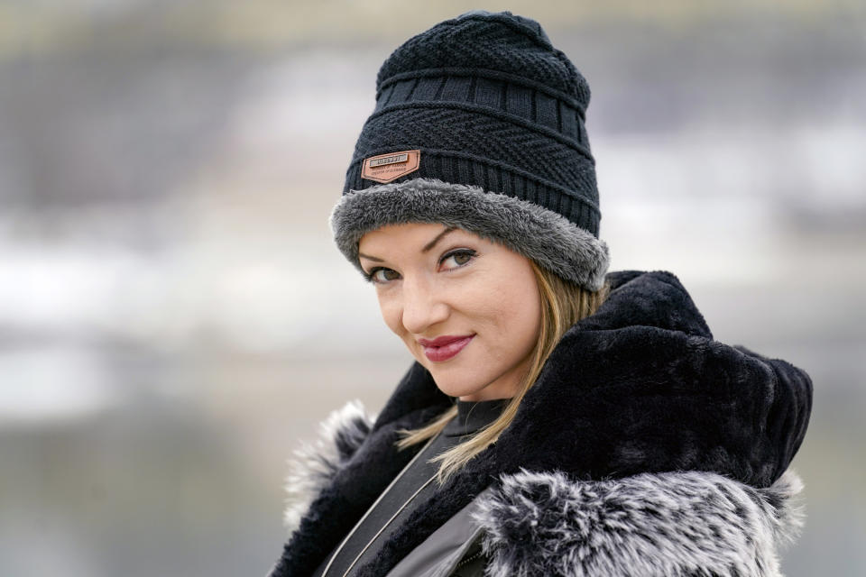 In this Monday, Feb. 8, 2021, photo, Allissa Star poses for a photograph along the north shore of the Allegheny River in Pittsburgh. Starr worked about a week every month at a brothel in Pahrump, Nevada, outside of Las Vegas. Then the pandemic led to the shuttering of Nevada's licensed bordellos, the only place where prostitution is legal in the state, and they have remained closed since March, leaving sex workers like Starr struggling to pay the bills and turning to alternatives like "virtual" dates. (AP Photo/Keith Srakocic)