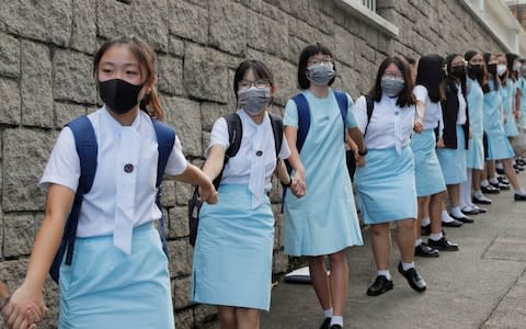 Students form human chain outside the Maryknoll Convent School in Hong Kong - Credit: Kin Cheung/AP