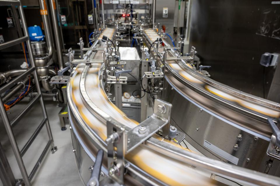 Packaged yogurt containers fly down the packaging line at the Danone North America facility in West Jordan on Thursday, Sept. 7, 2023. | Spenser Heaps, Deseret News