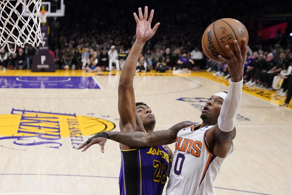 Phoenix Suns forward Torrey Craig, right, shoots as Los Angeles Lakers forward Rui Hachimura defends during the second half of an NBA basketball game Friday, April 7, 2023, in Los Angeles. (AP Photo/Mark J. Terrill)