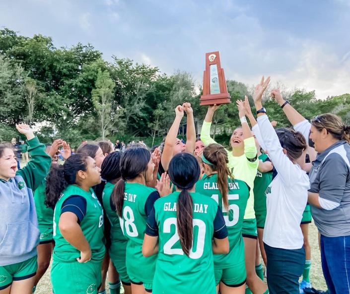 The girls of Glades Day hoist up the District 13-2A championship trophy after defeating Lake Worth Christian on Wednesday, Feb. 2, 2022.