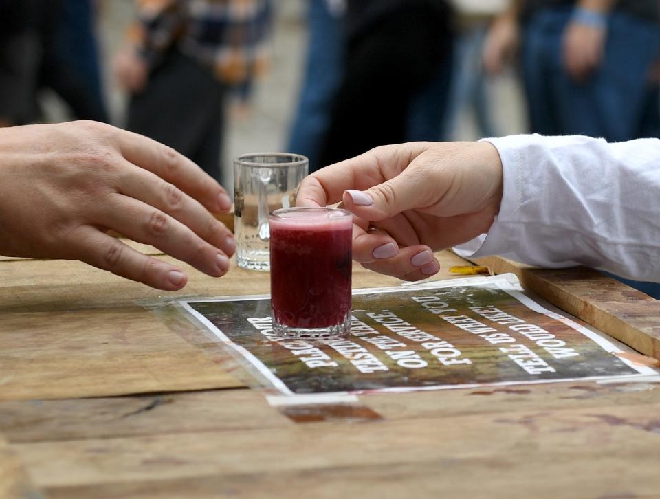 Janet Nowak receives a tasting of craft beer from Burley Oak Brewing Company at the Good Beer Festival Saturday, Oct. 9, 2021, at Pemberton Park in Salisbury, Maryland. The two day craft beer festival offered local beers, music, games and food,