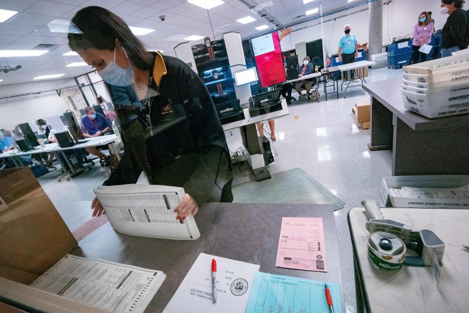 A poll worker sorts ballots inside the Maricopa County Election Department in Phoenix on Nov. 5, 2020. (Photo: OLIVIER  TOURON/AFP via Getty Images)