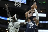 Dallas Mavericks' Christian Wood shooots past Milwaukee Bucks' Bobby Portis during the first half of an NBA basketball game Sunday, Nov. 27, 2022, in Milwaukee. (AP Photo/Morry Gash)