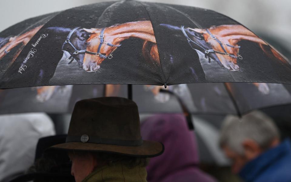 Trying to hide from the rain at Cheltenham - GETTY IMAGES