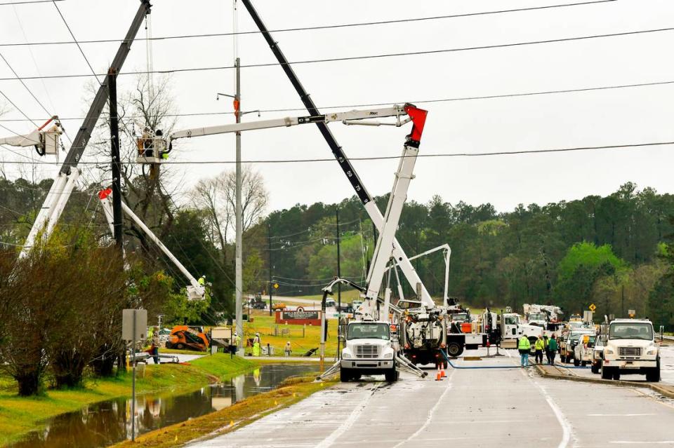Utilities crews work at the corner of W. Martin Luther King Jr. Dr. and Glynn St. near Atrium Health Navicent Baldwin in Milledgeville Monday afternoon. Strong storms hit the area over the weekend.