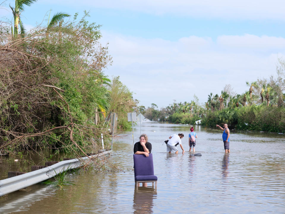 Homeowners in Fort Myers, Fla., walk outside their homes on Sept. 29, 2022 to assess damage and wait for help from relatives.<span class="copyright">Christopher Morris for TIME</span>