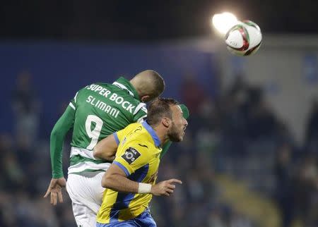 Arouca's Sema Velazquez (R) jumps for the ball with Sporting's Islam Slimani during their Portuguese Premier League soccer match at Municipal stadium in Arouca, Portugal, November 8, 2015. REUTERS/Miguel Vidal