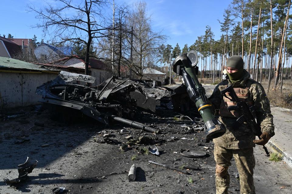 A Ukrainian soldier holds a Next Generation Light Anti-tank Weapon (NLAW) that was used to destroy a Russian armored personnel carrier (APC) in Irpin, north of Kyiv, on March 12, 2022.