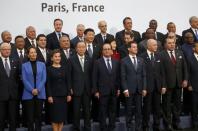 French President Francois Hollande (C, 1st row), United Nations Secretary General Ban Ki-moon (4th, 1st row) and Christiana Figueres (3rdL, 1st row), Executive Secretary of the UN Framework Convention on Climate Change, pose for a family photo with head of states and government during the opening day of the World Climate Change Conference 2015 (COP21) in Le Bourget, near Paris, France, November 30, 2015. REUTERS/Jacky Naegelen