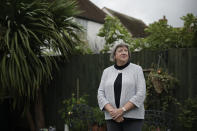 Mayflower descendant Vicky Cosstick poses for a portrait in the back garden of her home in the town of Seaford, on the south coast of England, Friday, Oct. 2, 2020. Cosstick said she's troubled by the suffering the indigenous people endured, but she doesn't feel guilt. "I'm of course horrified and appalled to know what happened as a result of British colonialism in America and what happened to their Native American tribes and the Wampanoags," Cosstick said. "It's not as if they went to America in order to steal land from an indigenous population," she said. "Much of it was clearly wrong, but there are many stories that need to be told. And I think the anniversary gives a chance for all of those stories to be told." (AP Photo/Matt Dunham)