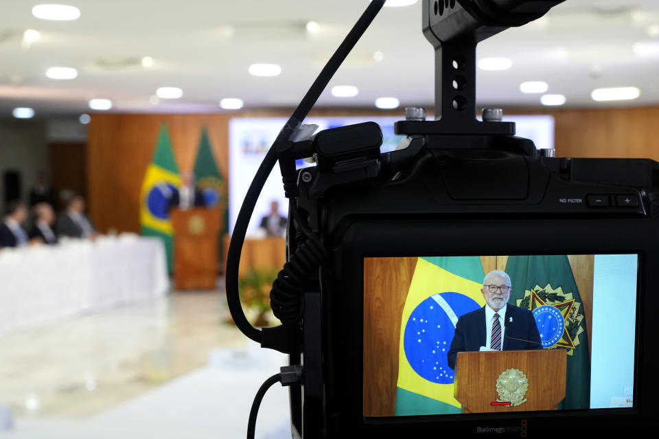 Seen on a camera viewfinder, Brazilian President Luiz Inacio Lula da Silva speaks during a ministerial meeting to review the first 100 days of his government at Planalto Palace in Brasilia, Brazil, Monday, April 10, 2023. (AP Photo/Eraldo Peres)