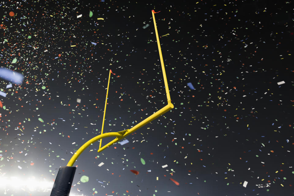 American football stadium goalpost and confetti - stock photo