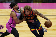 Miami Heat guard Gabe Vincent (2) defends against Golden State Warriors guard Kelly Oubre Jr. (12) during the first half of an NBA basketball game, Thursday, April 1, 2021, in Miami. (AP Photo/Marta Lavandier)