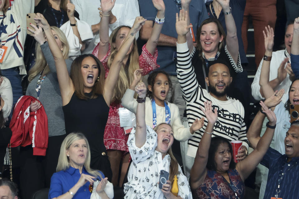 NANTERRE, FRANCE - JULY 27: Chrissy Teigen and John Legend celebrate the gold medal of the USA 4x100m freestyle relay during day one of the swimming event at Paris La Defense Arena on July 27, 2024 in Nanterre near Paris, France. (Photo by Jean Catuffe/Getty Images)