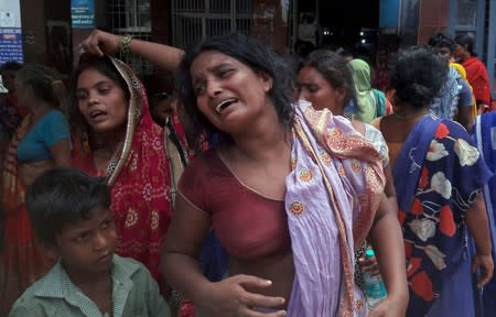 Relatives of the victims of a mob lynching incident mourn outside a hospital in Chapra