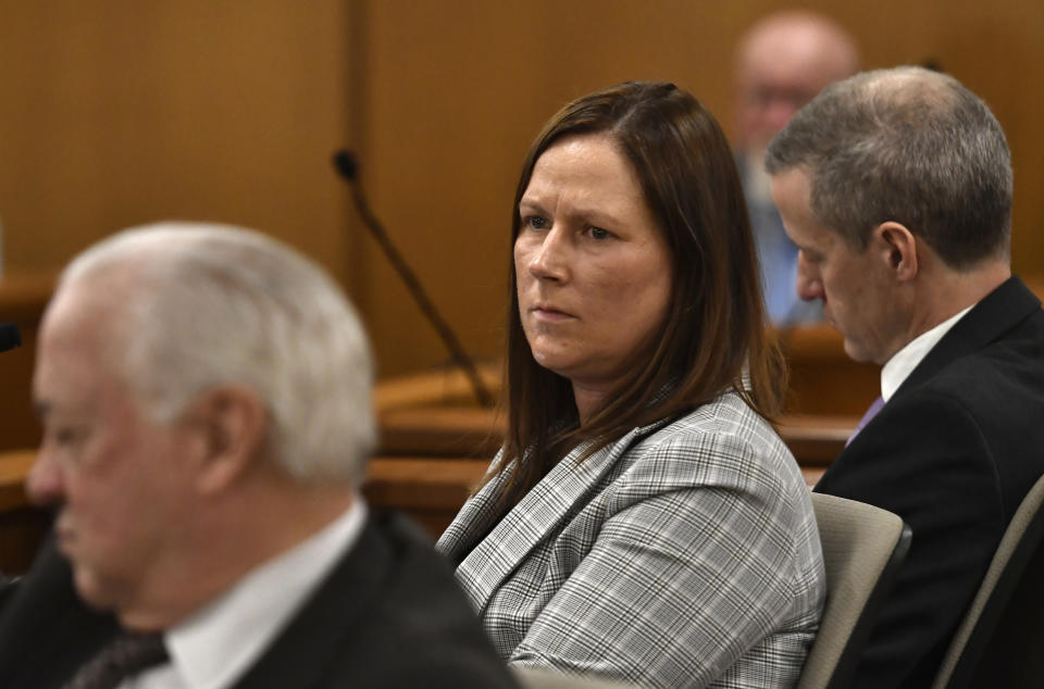 Bridget Krause, one of Mark Jensen's attorneys, center, listens as the state's opening statement during Jensen's trial at the Kenosha County Courthouse on Wednesday, Jan. 11, 2023, in Kenosha, Wis. The Wisconsin Supreme Court ruled in 2021 that Jensen deserved a new trial in the 1998 death of his wife Julie Jensen, who was poisoned with antifreeze. (Sean Krajacic/The Kenosha News via AP, Pool)