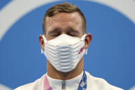 Caeleb Dressel of the United States closes his eyes on the podium after receiving his gold medal for the men's 100-meter freestyle at the 2020 Summer Olympics, Thursday, July 29, 2021, in Tokyo, Japan. (AP Photo/Matthias Schrader)