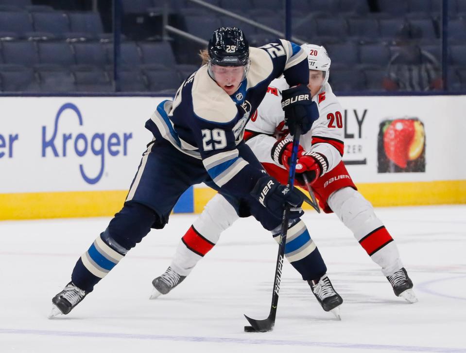 Columbus Blue Jackets right wing Patrik Laine (29) brings the puck up ice ahead of Carolina Hurricanes right wing Sebastian Aho (20) during the third period of the NHL hockey game at Nationwide Arena in Columbus on Sunday, Feb. 7, 2021. The Blue Jackets lost 6-5.