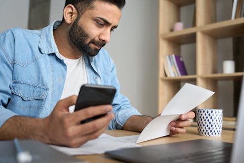 <span class="caption">There are steps all users can take to make banking apps as secure as possible.</span> <span class="attribution"><a class="link " href="https://www.shutterstock.com/image-photo/young-indian-businessman-holding-phone-reading-2002154225" rel="nofollow noopener" target="_blank" data-ylk="slk:Ground Picture/Shutterstock;elm:context_link;itc:0;sec:content-canvas">Ground Picture/Shutterstock</a></span>