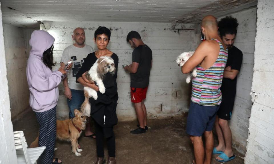 People take shelter in the basement of a building in the Israeli city of Tel Aviv after rockets were launched towards Israel from the Gaza Strip.