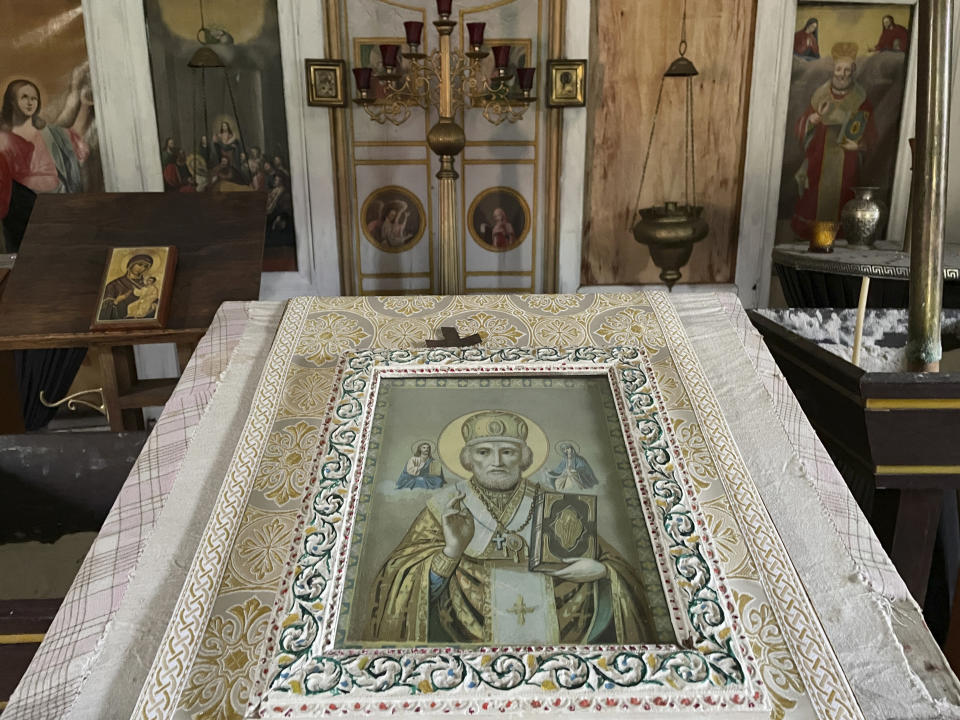 Icons and other religious artifacts are seen inside the old St. Nicholas Church in Eklutna, Alaska, on Oct. 13, 2023. A restoration effort has begun on the church, which is the oldest standing building in the Municipality of Anchorage. (AP Photo/Mark Thiessen)