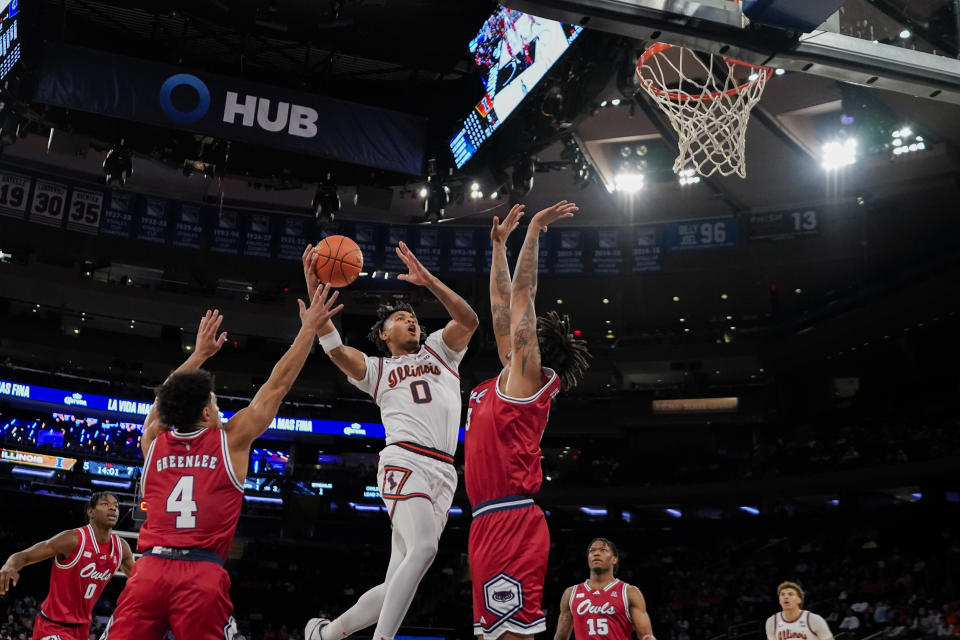 Illinois' Terrence Shannon Jr. (0) shoots between Florida Atlantic's Bryan Greenlee (4) and Giancarlo Rosado, right, during the first half of an NCAA college basketball game in New York, Tuesday, Dec. 5, 2023. (AP Photo/Peter K. Afriyie)