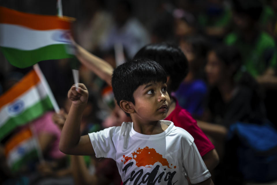 Schoolchildren celebrate the successful landing of spacecraft Chandrayaan-3 on the moon, in a school in Guwahati, India, Wednesday, Aug. 23, 2023. India has landed a spacecraft near the moon's south pole, an unchartered territory that scientists believe could hold vital reserves of frozen water and precious elements, as the country cements its growing prowess in space and technology. (AP Photo/Anupam Nath)