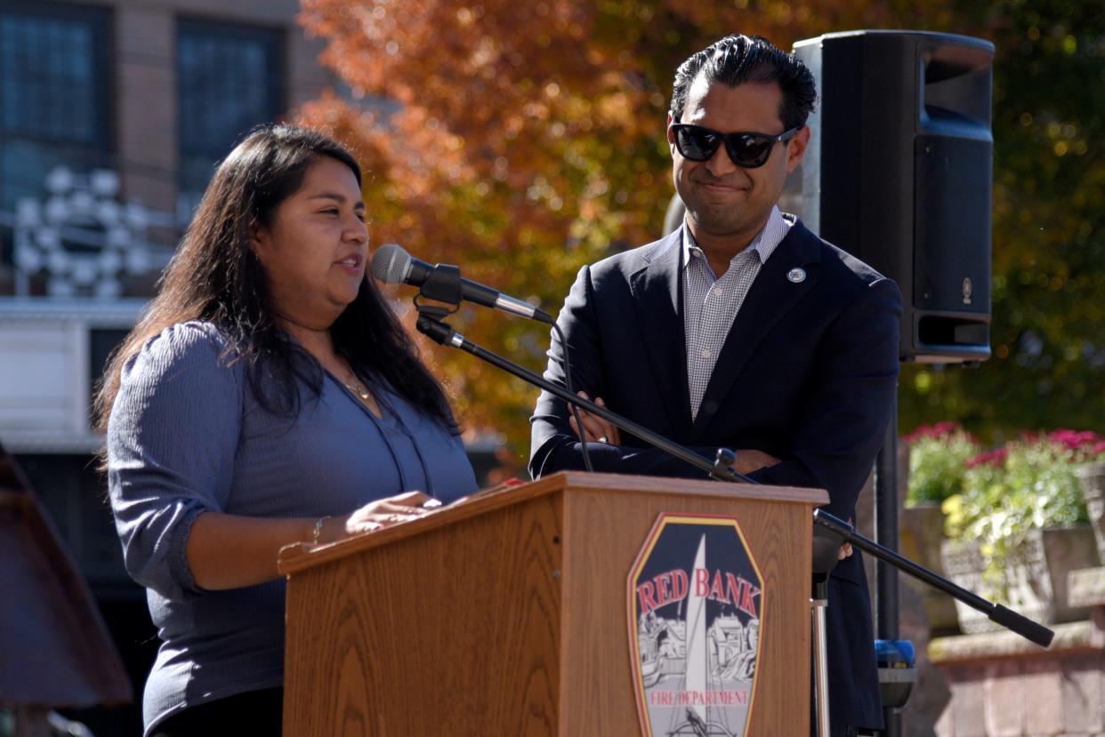 State Sen. Vin Gopal, D-Monmouth, right, waits as Itzel Perez Hernandez translates the conference for winter resources into Spanish on Thursday, October 26, 2023 outside borough hall in Red Bank, New Jersey.