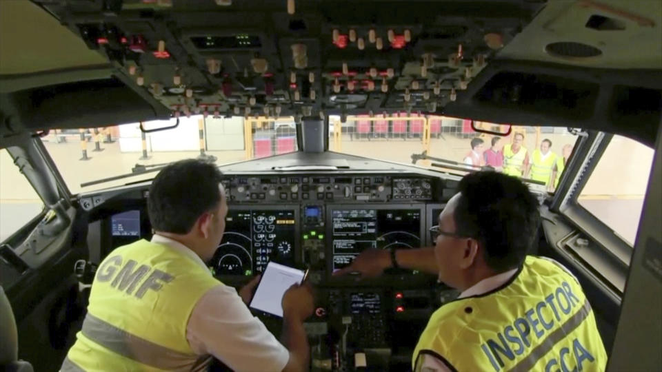 In this image from video taken on Tuesday, March 12, 2019, officials make inspection inside the cockpit of a Boeing 737 Max 8 aircraft is in hangar at Garuda Maintenance Facility at Soekarno Hatta airport, Jakarta. The Indonesian Transport Ministry on Tuesday conducted inspections of 737 Max 8 aircraft owned by Garuda Indonesia and Lion Air. (AP Photo)