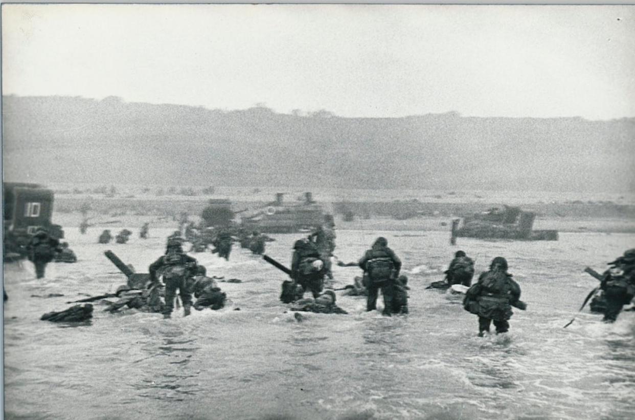 One of war photographer Robert Capa's images shows a wave of troops arriving on the Normandy beaches on D-Day. <a href="https://americanhistory.si.edu/collections/nmah_1916407" rel="nofollow noopener" target="_blank" data-ylk="slk:Robert Capa via National Museum of American History;elm:context_link;itc:0;sec:content-canvas" class="link ">Robert Capa via National Museum of American History</a>