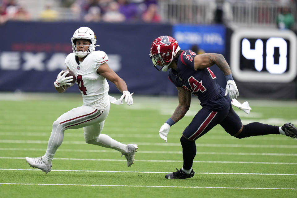 Arizona Cardinals wide receiver Rondale Moore (4) runs the ball as Houston Texans cornerback Derek Stingley Jr. (24) gives chase in the first half of an NFL football game in Houston, Sunday, Nov. 19, 2023. (AP Photo/Eric Christian Smith)