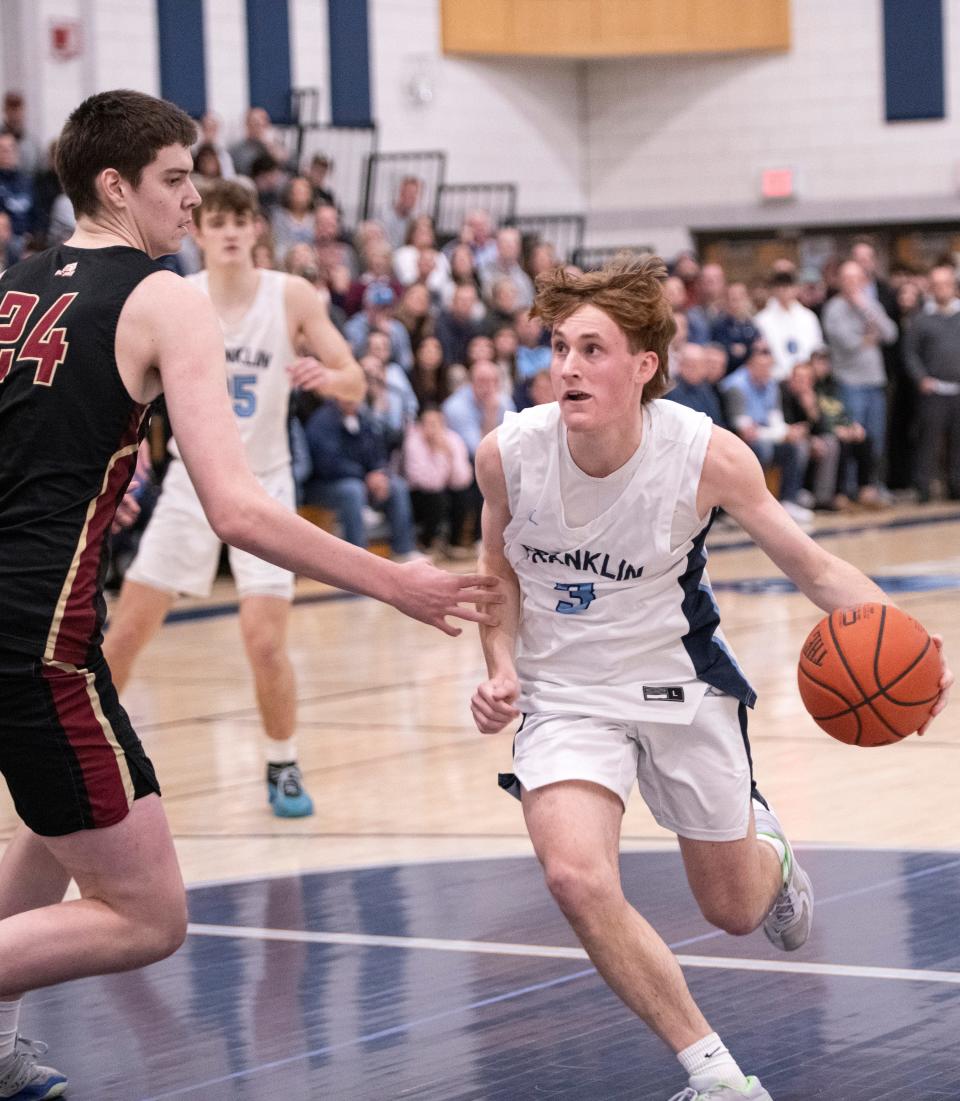 Franklin senior Bradley Herndon gets around BC High senior Dan Civello during the Division 1 Elite 8 game at Franklin High, March 9, 2024. The Panthers beat the Eagles, 66-49.